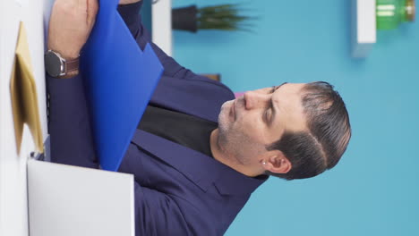 Vertical-video-of-Successful-businessman-working-happily-on-paperwork-files.